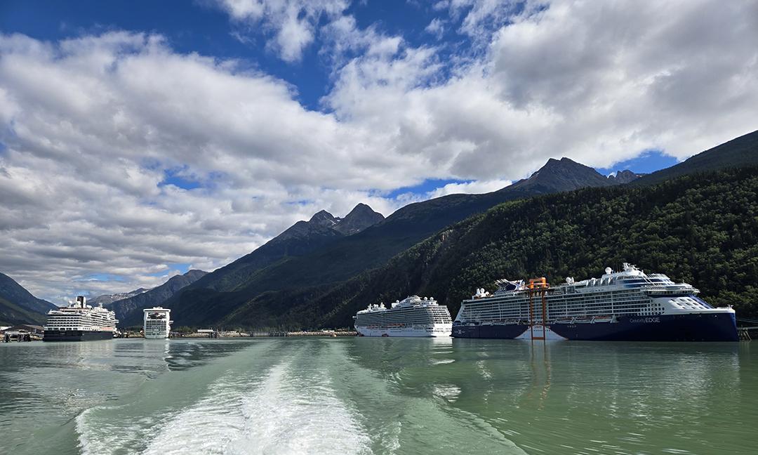 Panorama of the Skagway, Alaska, on August 12. Calling at the northernmost Inside Passage port are (from left to right) Holland America Konigsdam, Caribbean Princess, Royal Princess, and Celebrity Edge. Photo courtesy of Mike Cheek.