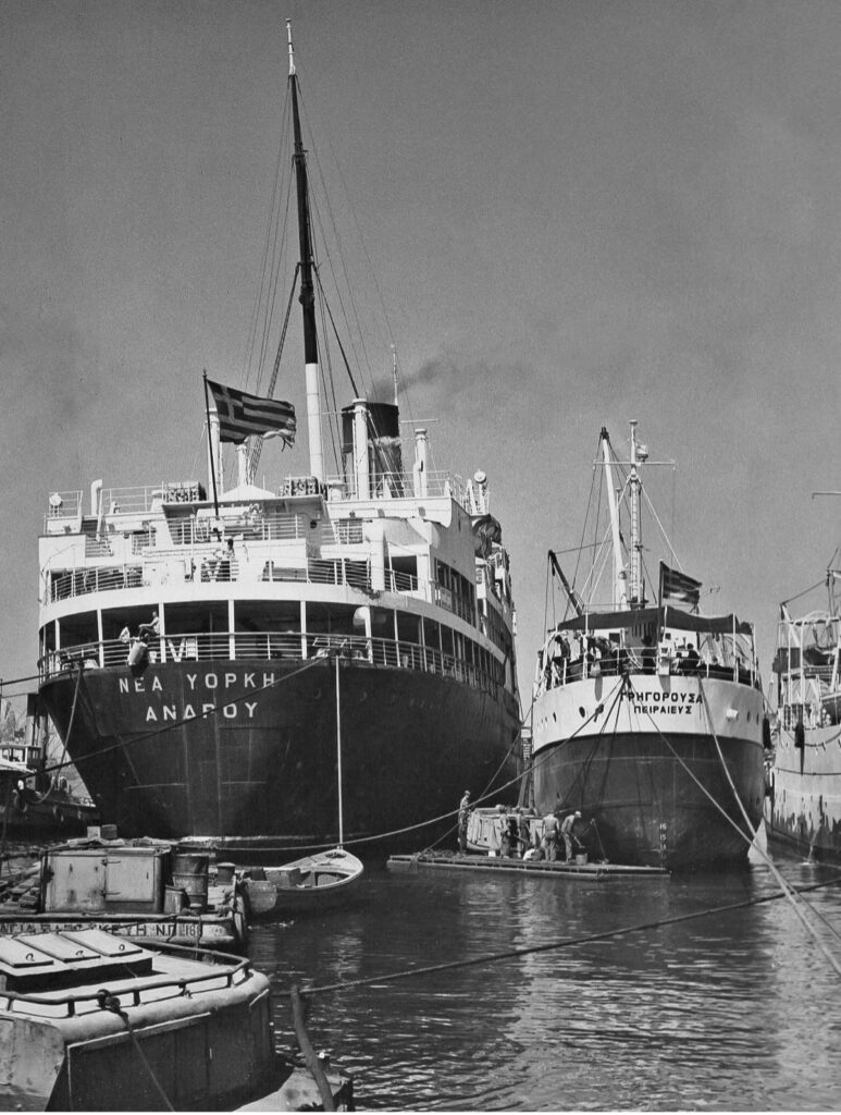 Greek Lines New York (left) and cargo vessel Grigorousa docked in Piraeus, Greece, in the late 1950's. From the William H. Miller Collection.