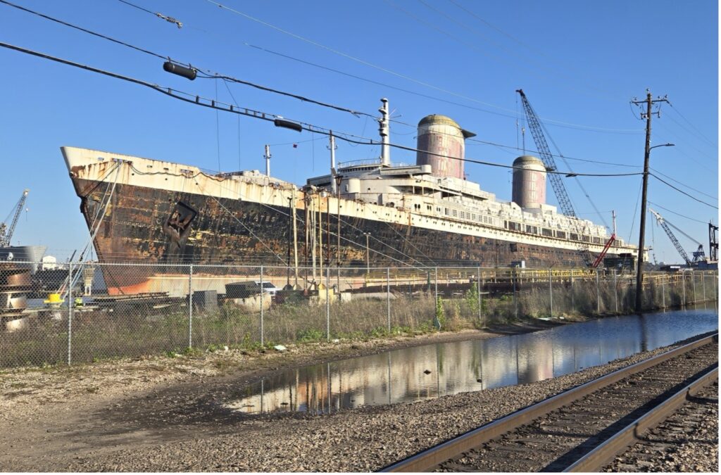 A view of SS United States from outside the chain-link fence at Mobile, Alabama. Photo credit: Richard Weiss.
