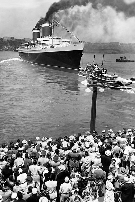 Spectators watch the departure of SS United States from Pier 86. From the William H. Miller Collection.