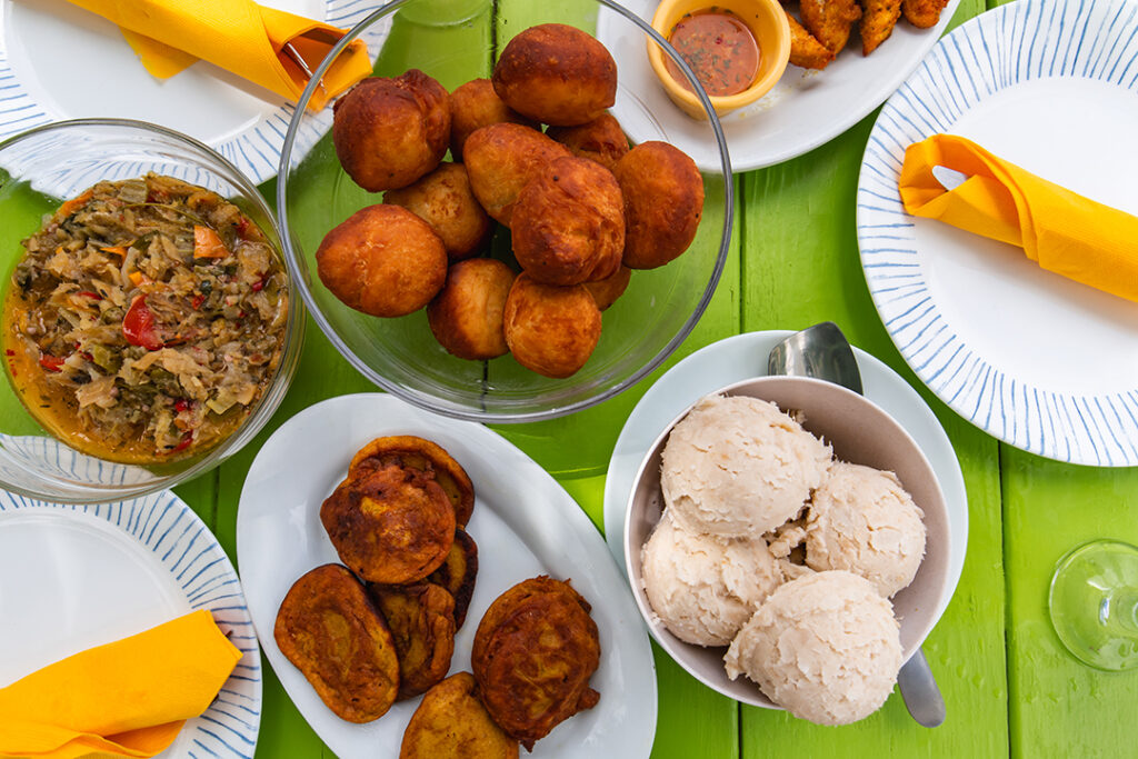 A colorful Nevisian spread of saltfish, Johnny cakes, plantains, and breadfruit — a delicious taste of island life and local flavor. Image courtesy of Greg Philip.