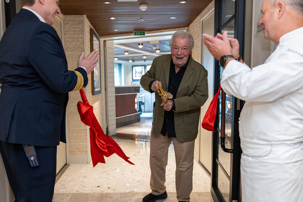 Emmy-winning PBS host Jacques Pépin cuts the ribbon at a reopening of his onboard restaurant Jacques aboard Oceania Allura in Boston on Oct. 6, 2025. Image courtesy of Oceania Cruises.