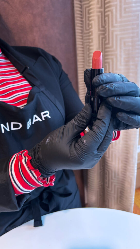 Guest creating a custom lipstick shade at Holland America Line’s Blend Bar onboard Nieuw Statendam