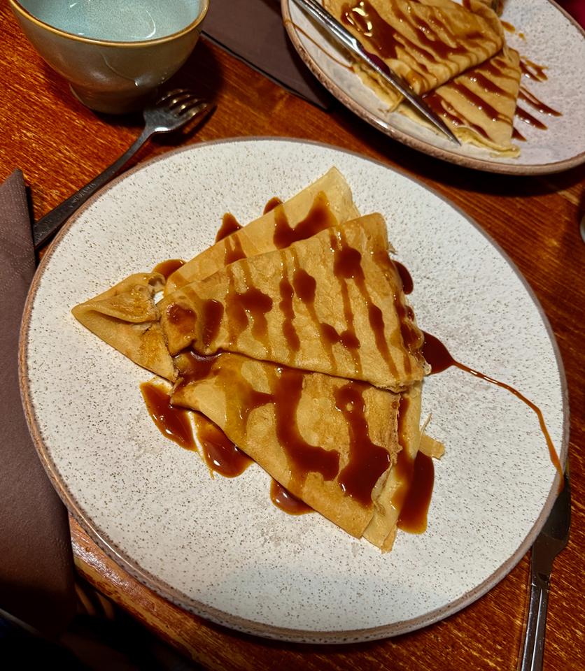 A plate of crêpes served with caramel sauce. Credits: Monte Mathews.