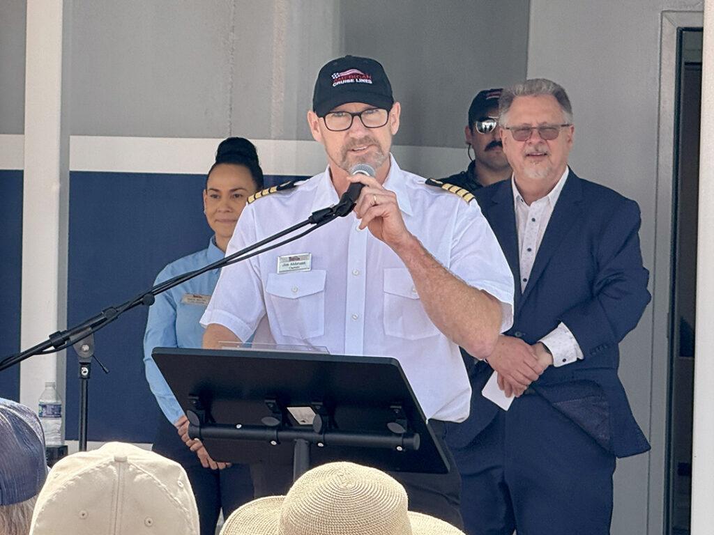 Captain Jim Abbruzzi addresses attendees during the christening ceremony for American Pioneer at Mallory Square in Key West on Monday. Photo credit: CruiseNews.