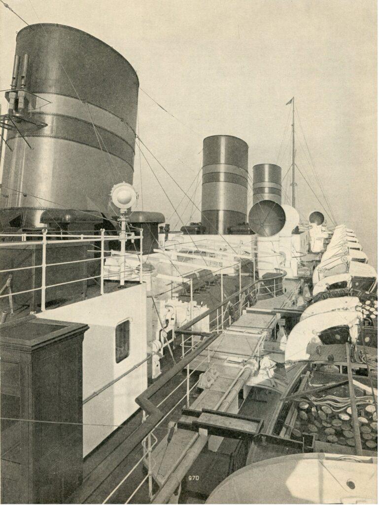 Looking aft along the boat deck of the Furness-Bermuda Line’s Queen of Bermuda, showing her distinctive three-funnel profile that earned her the nickname “the Honeymoon Ship of the Atlantic.” From the William H. Miller collection.