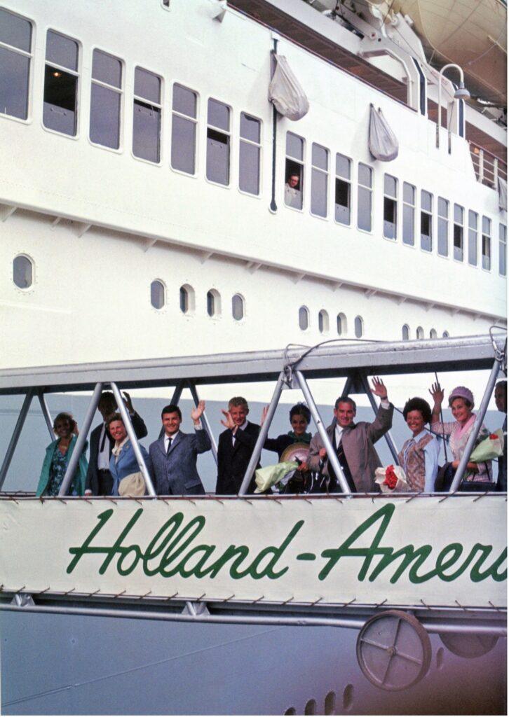 Gangway moment captures passengers waving as they board a Holland America liner. From the William H. Miller collection.
