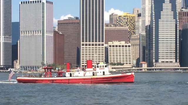 The restored 1931 fireboat John J. Harvey sails along the Manhattan waterfront, a living icon known for saluting cruise ships and welcoming vessels to New York Harbor. Credit: René Mack.