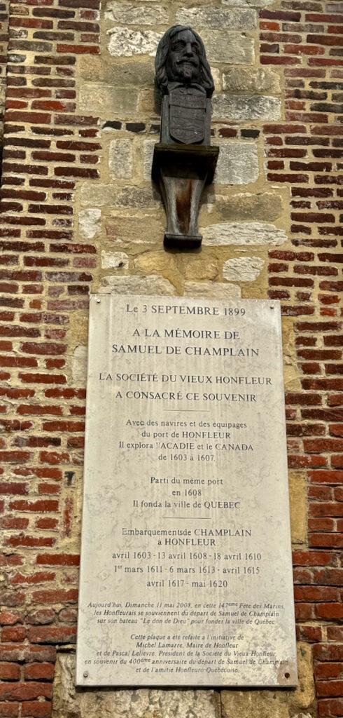 A memorial plaque and bust in Honfleur honoring Samuel de Champlain, the navigator who launched several voyages from this port and went on to found the city of Québec in 1608. Credit: Monte Mathews.