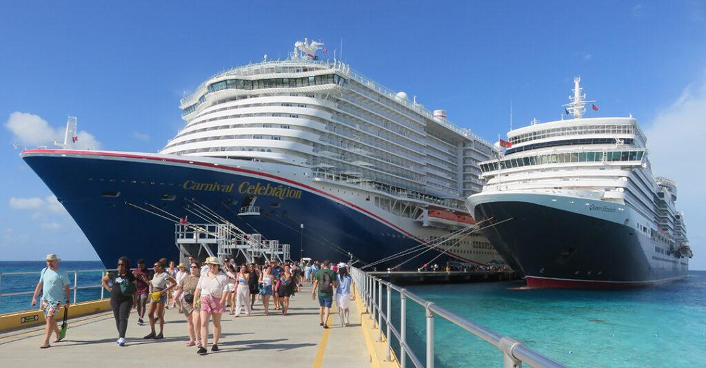 Cunard’s Queen Elizabeth and Carnival Cruise Line’s Carnival Celebration dock side by side at Grand Turk on Dec. 16, 2025, as passengers come ashore in the Turks and Caicos. Credit: William H. Miller.