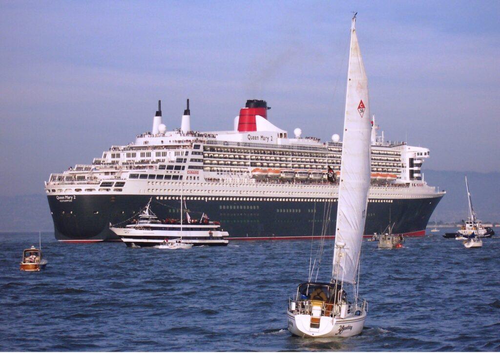 Queen Mary 2 sails into San Francisco Bay during her 2008 debut visit, surrounded by excursion boats and sails in a celebratory escort. Courtesy of the William H. Miller collection.