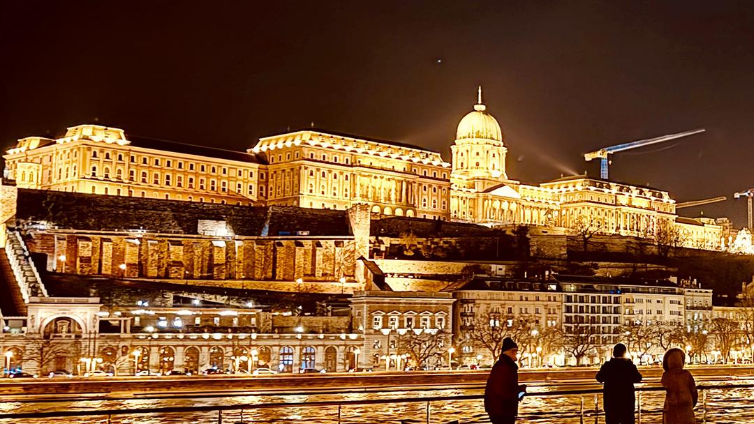 An evening departure from Budapest offers riverfront views of the illuminated Hungarian Parliament Building. Photo credit: H. Liu.
