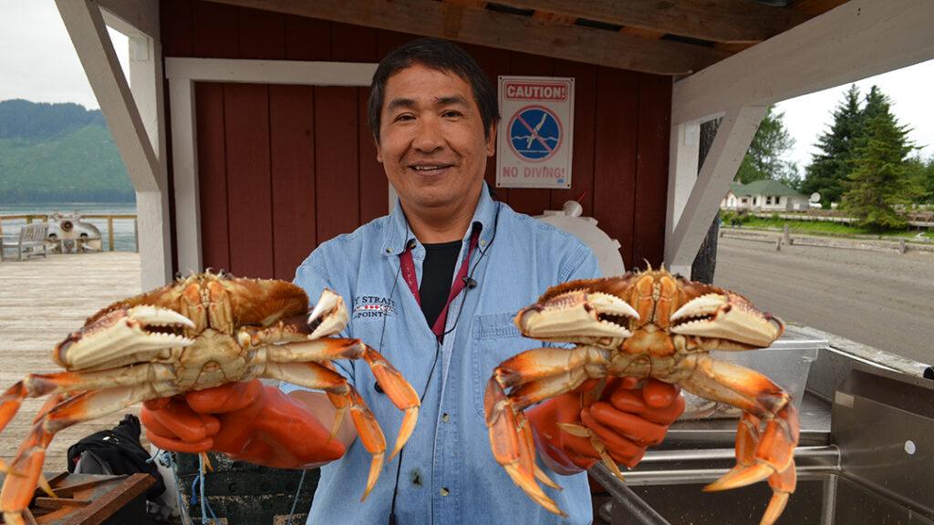 A local guide displays freshly caught Dungeness crabs at Icy Strait Point in Hoonah, Alaska. Courtesy of Huna Totem Corporation.
