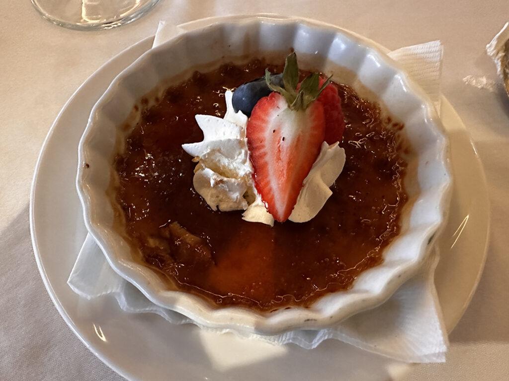 Salted caramel crème brûlée, topped with whipped cream and fresh berries, is served aboard American Encore. Photo: Gerry Barker