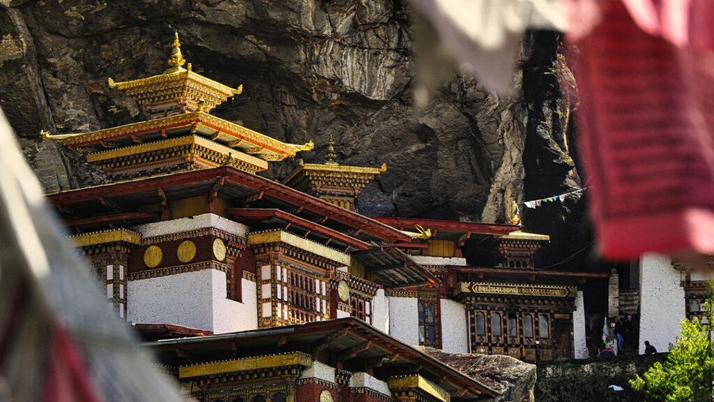 A traditional Bhutanese temple set beneath a dramatic rock face. Bhutan is featured on Passage Journeys’ “The Pursuit of Happiness in Bhutan” itinerary. Photo courtesy of Passage Journeys.