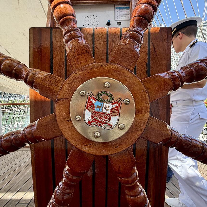 Peru’s coat of arms adorns the center of a traditional wooden wheel aboard B.A.P. Unión. Photo: H. Liu