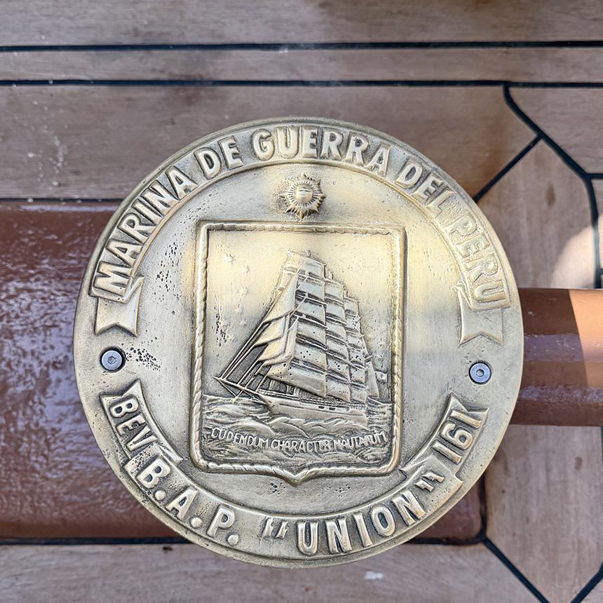 A brass-topped capstan aboard B.A.P. Unión bears the emblem of the Peruvian Navy and an image of the four-masted training ship. Photo: H. Liu