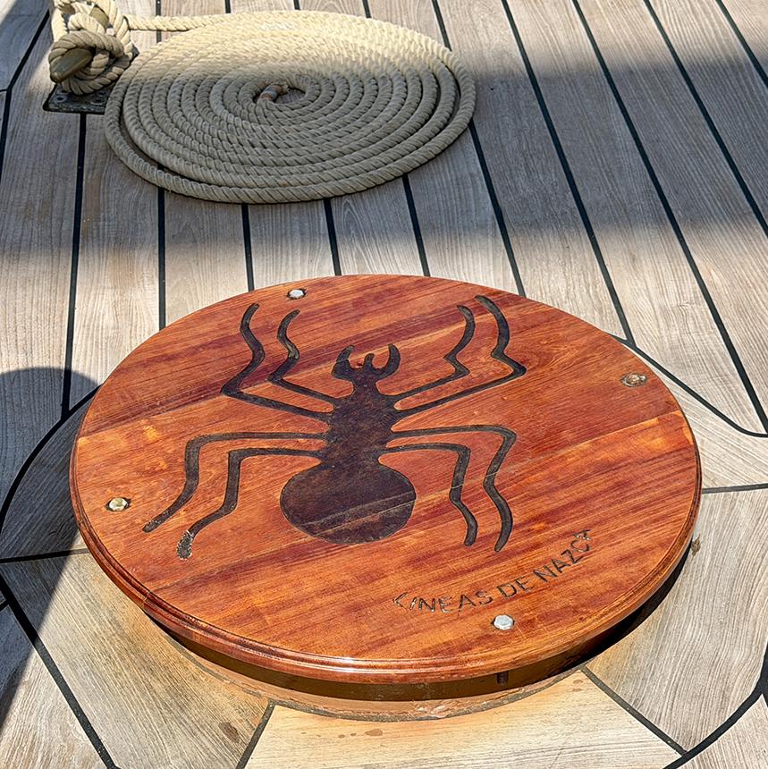 The spider geoglyph from Peru’s Nazca Lines is depicted on a wooden deck cover aboard B.A.P. Unión. Photo: H. Liu