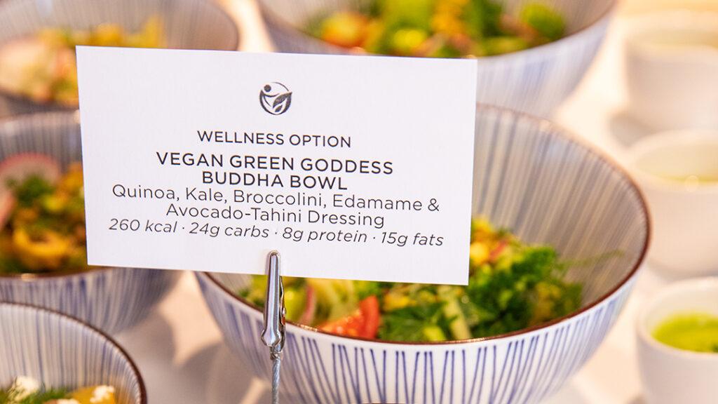A vegan Green Goddess Buddha Bowl is labeled with calories, carbohydrates, protein, and fat as part of Crystal’s wellness culinary offerings. Credit: Crystal Cruises