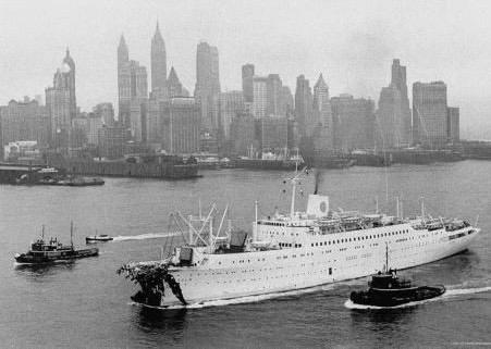 Stockholm returns to New York on July 27, 1956, escorted by tugs after the Andrea Doria collision. From the William H. Miller Collection.